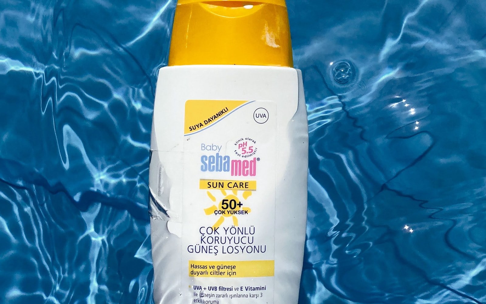 Sebamed sun lotion floating in blue water