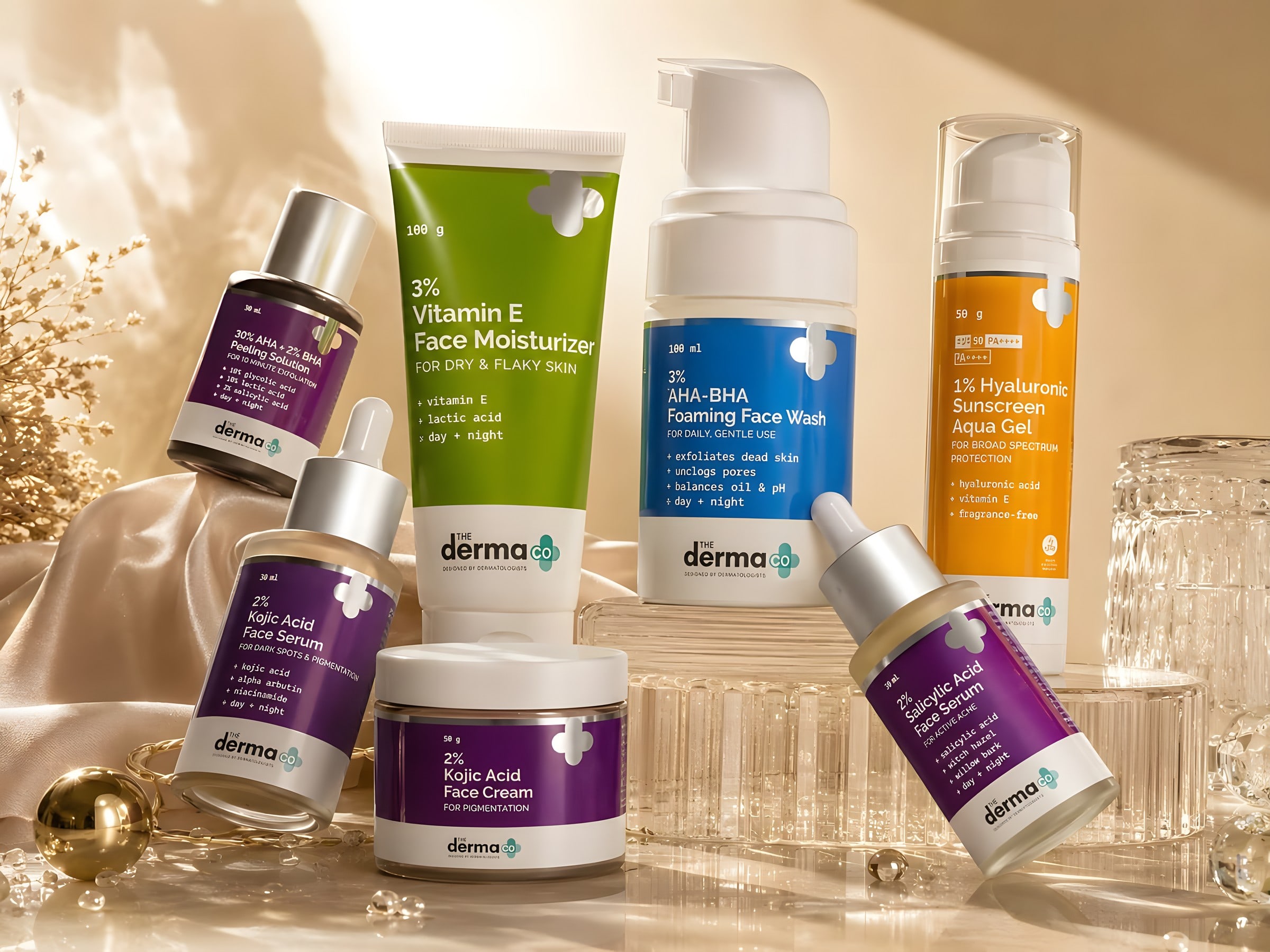 The Derma Co serums, face wash, moisturiser and sunscreen arranged in warm light